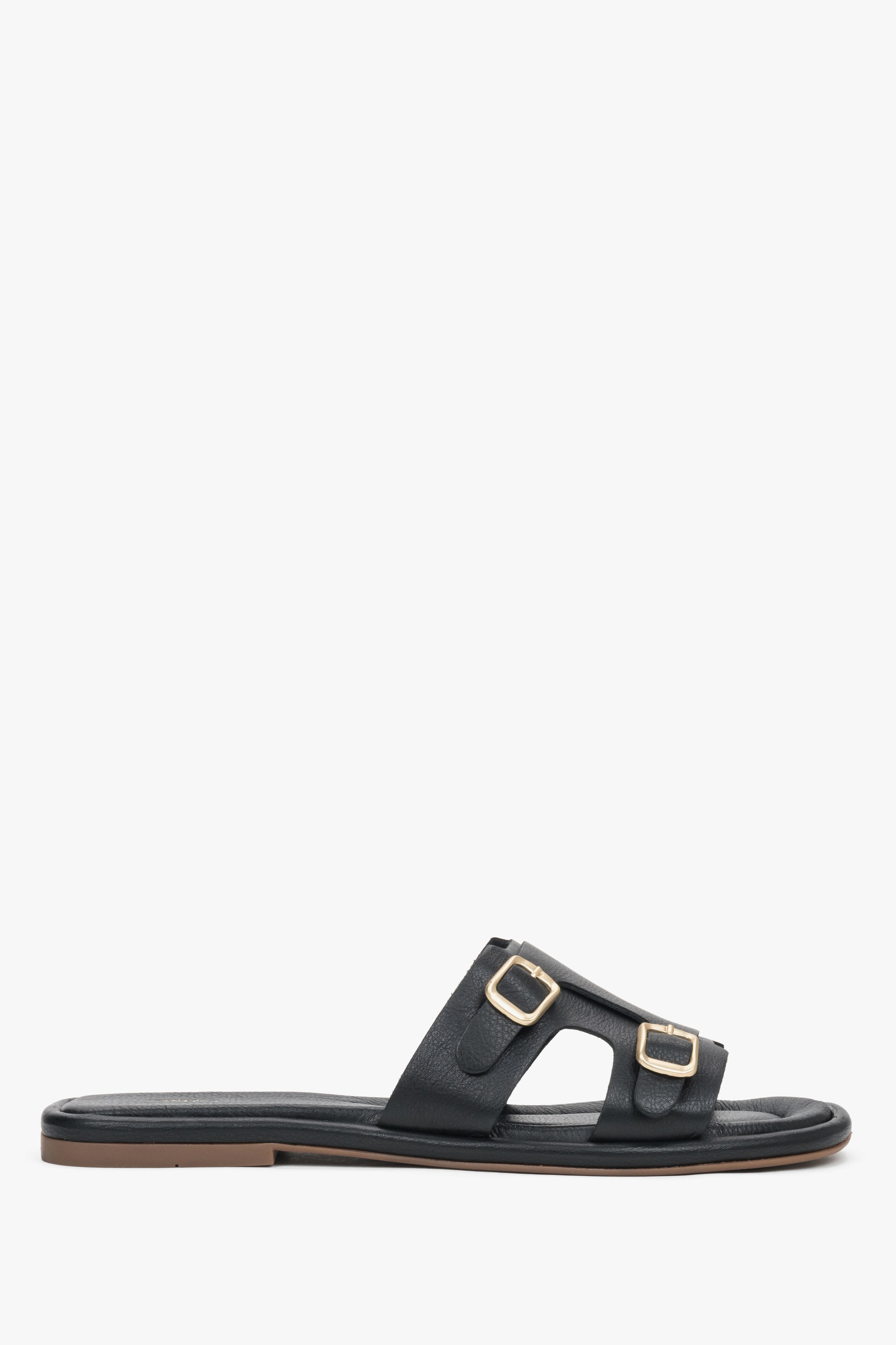 Women's black genuine leather slide sandals with large, decorative gold buckles Estro, showcasing a bold, elegant summer design.