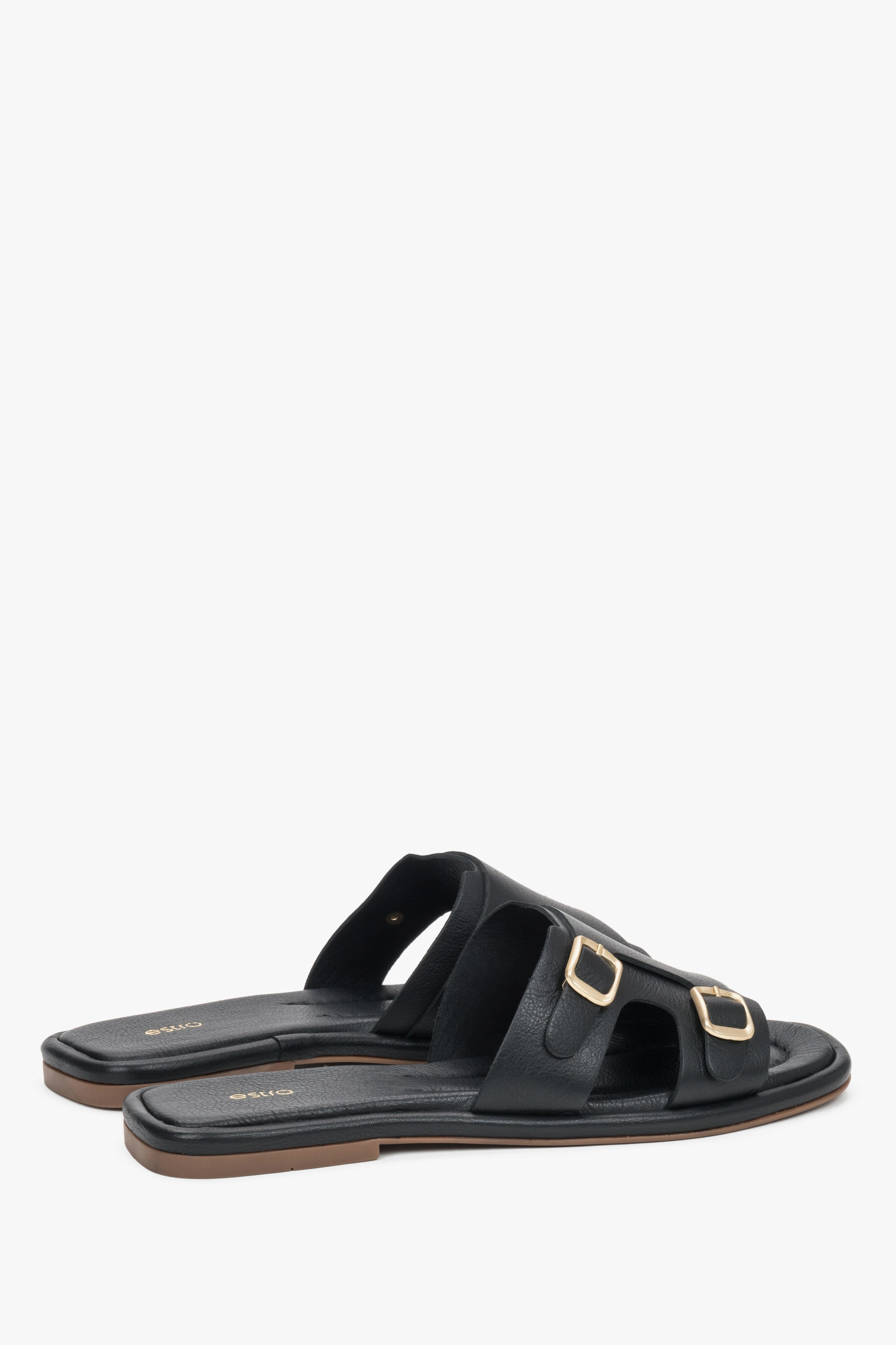 The back of the shoe showing the clean cuts, minimalist silhouette, and stable sole construction of the luxury slide sandals.