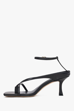 Black leather thong-strap heeled sandals with a square toe, summer style.