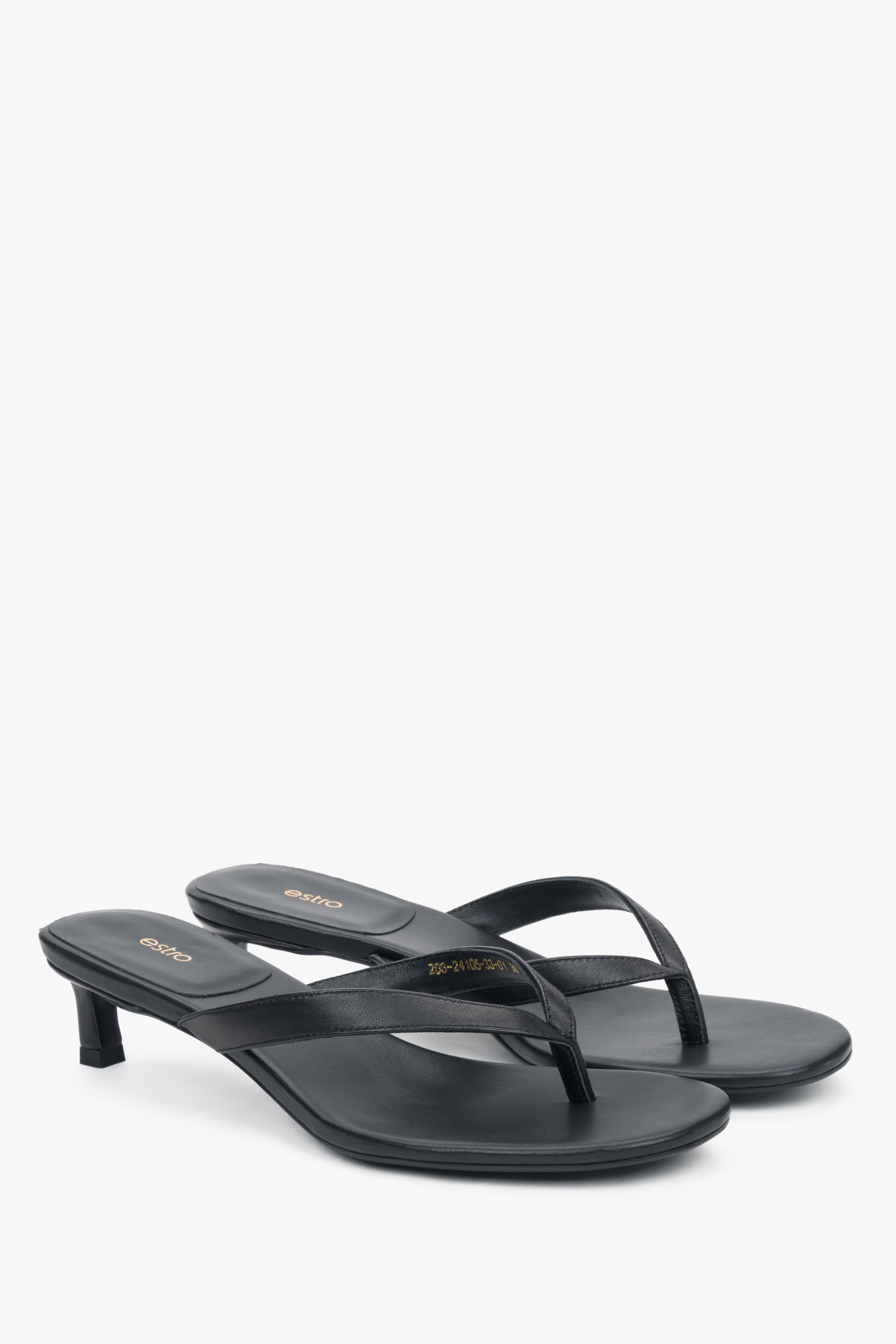 Women’s black leather thong sandals with a low heel.