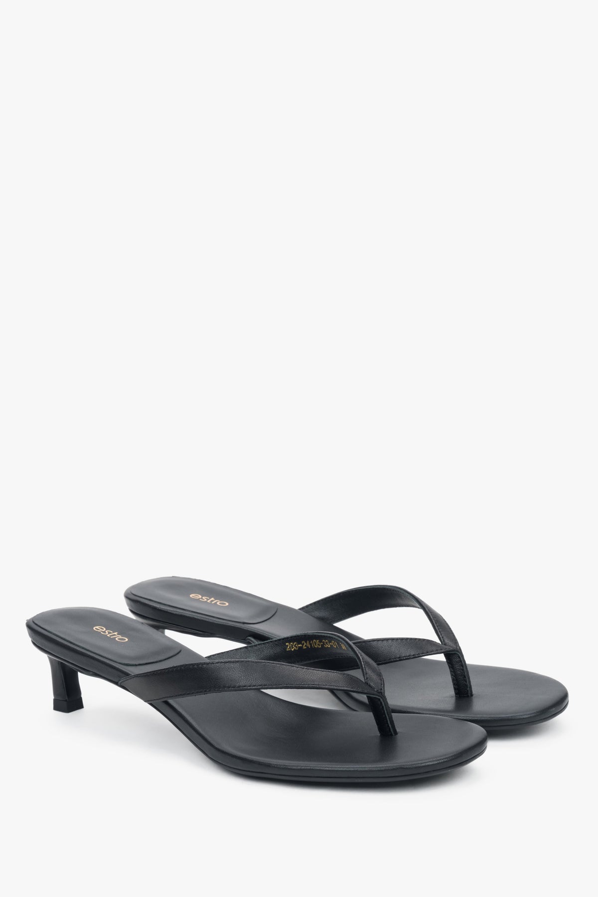 Women’s black leather thong sandals with a low heel.