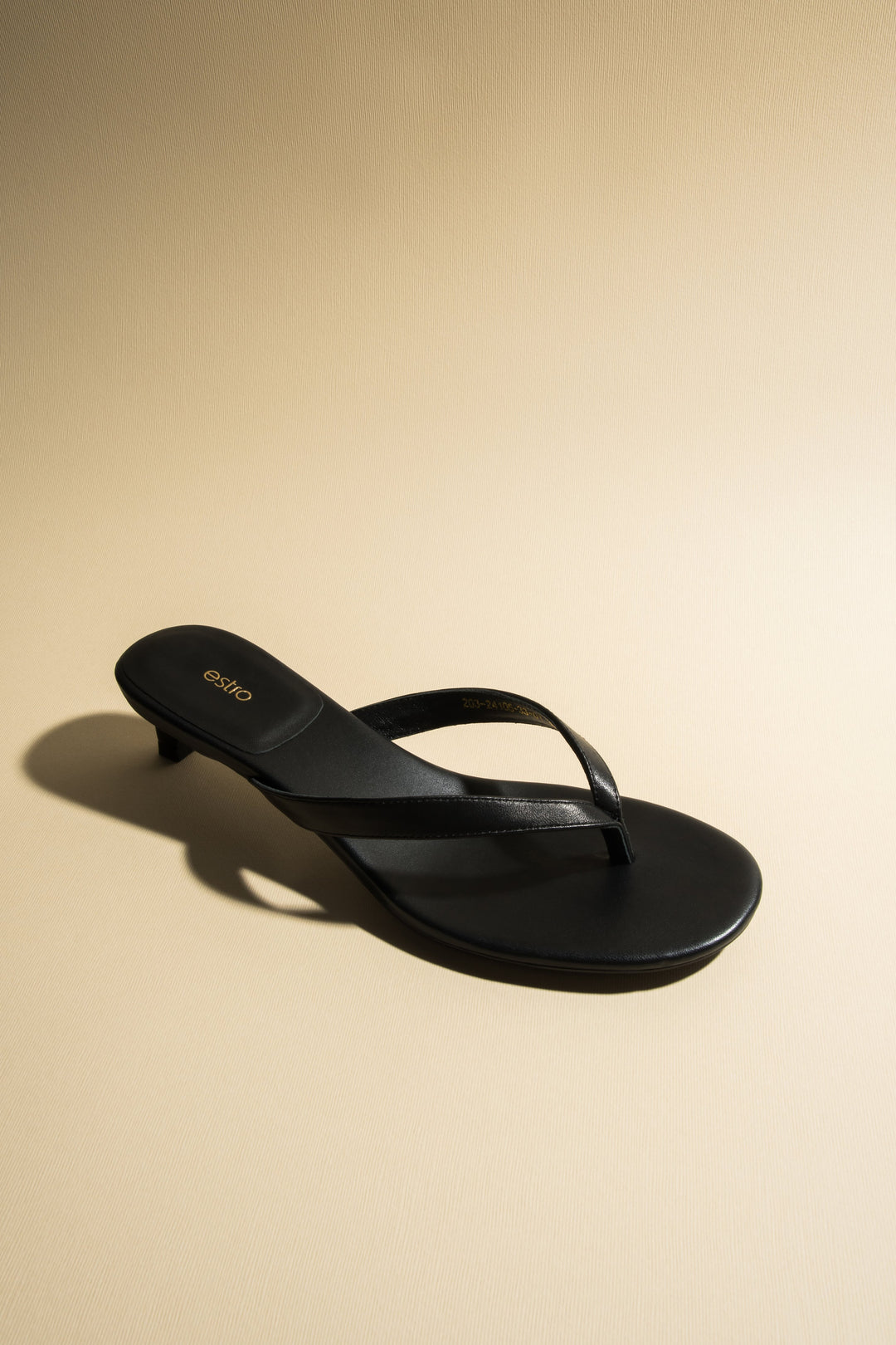 Women’s black thong sandals with a low heel by Estro.