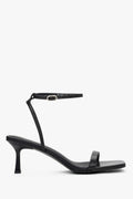 Women's black leather funnel heel sandals by Estro with silver details.