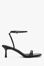 Women's black leather funnel heel sandals by Estro with silver details.