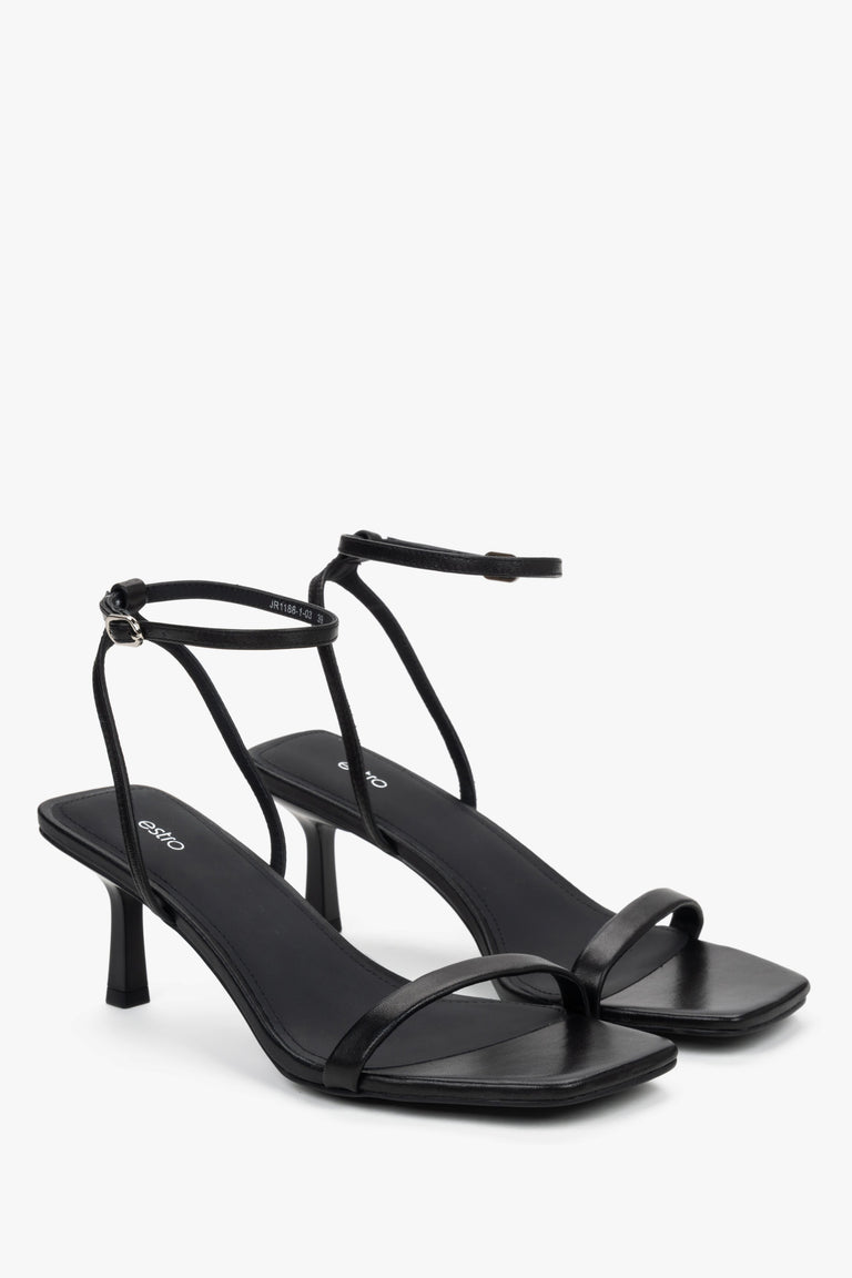 Side view of women's black leather sandals with stable funnel heel.