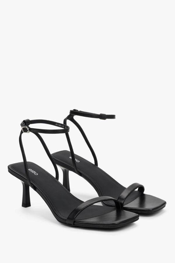 Side view of women's black leather sandals with stable funnel heel.