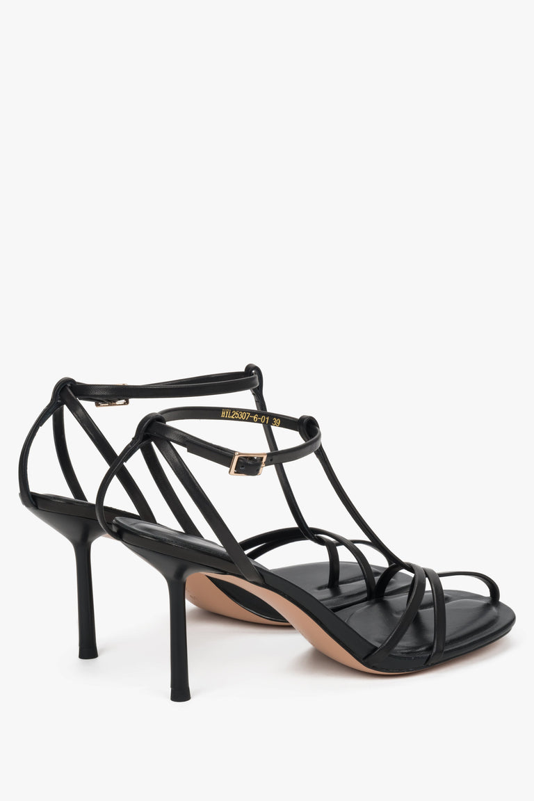 Women's black leather high heel sandals styled with Estro packaging