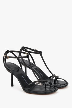 Front angled view of women's black leather sandals with thin straps