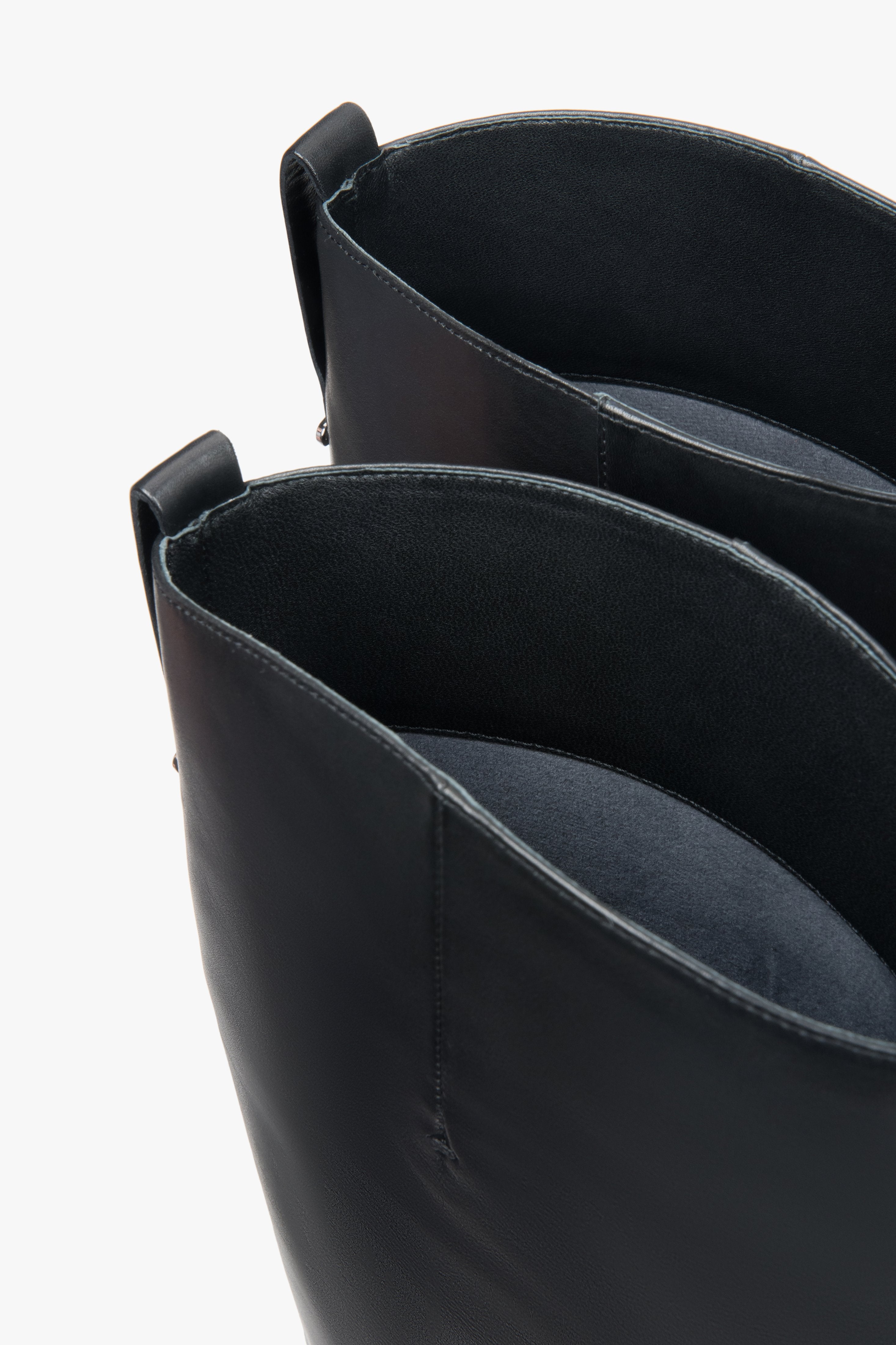 Black women’s leather knee-high boots with a wide shaft – full outfit look.