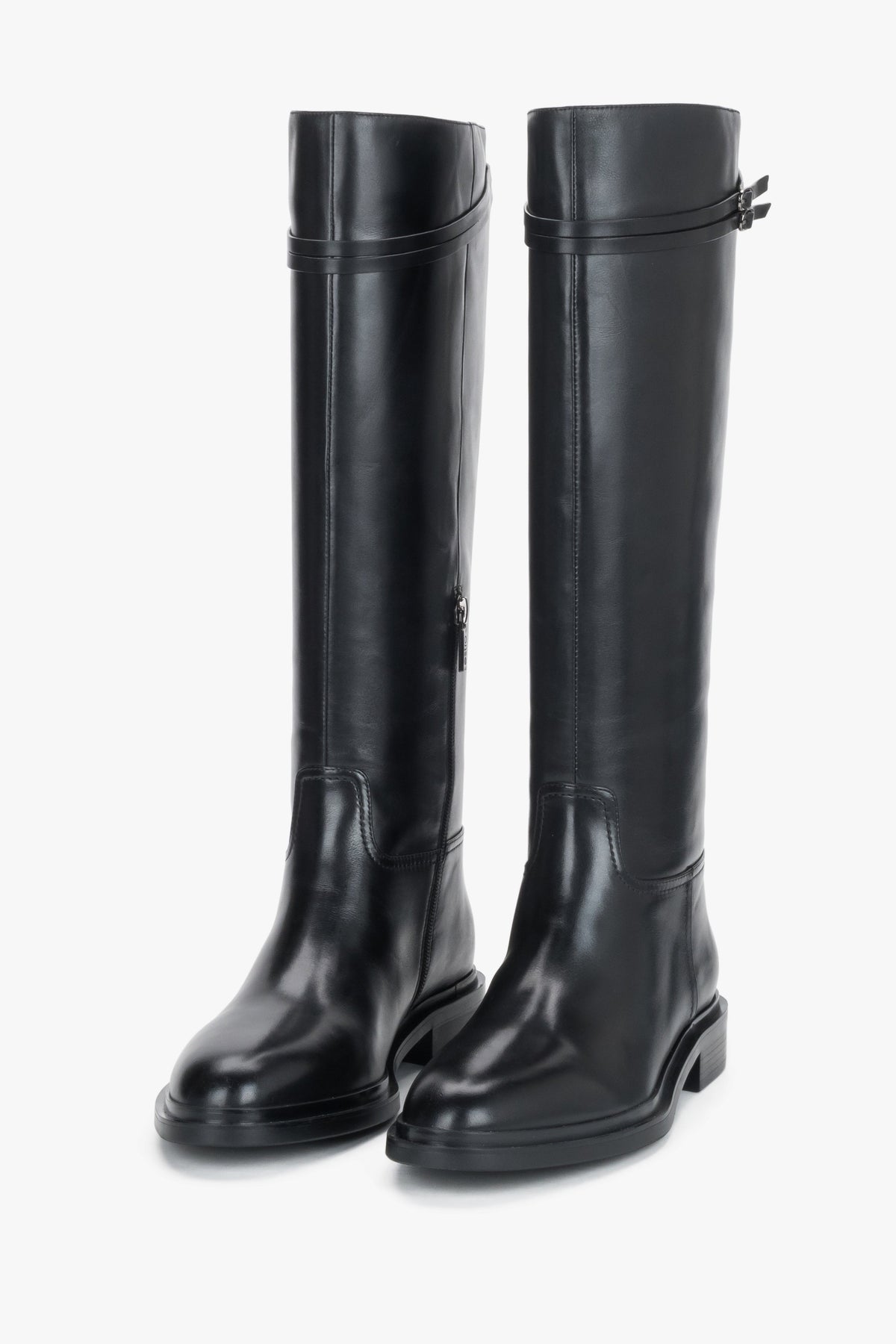 Women's black leather knee-high riding boots Estro - front view showing the sleek silhouette and buckle detail.