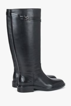 Women's black leather knee-high boots Estro - side view highlighting the classic profile and ankle buckle accent.