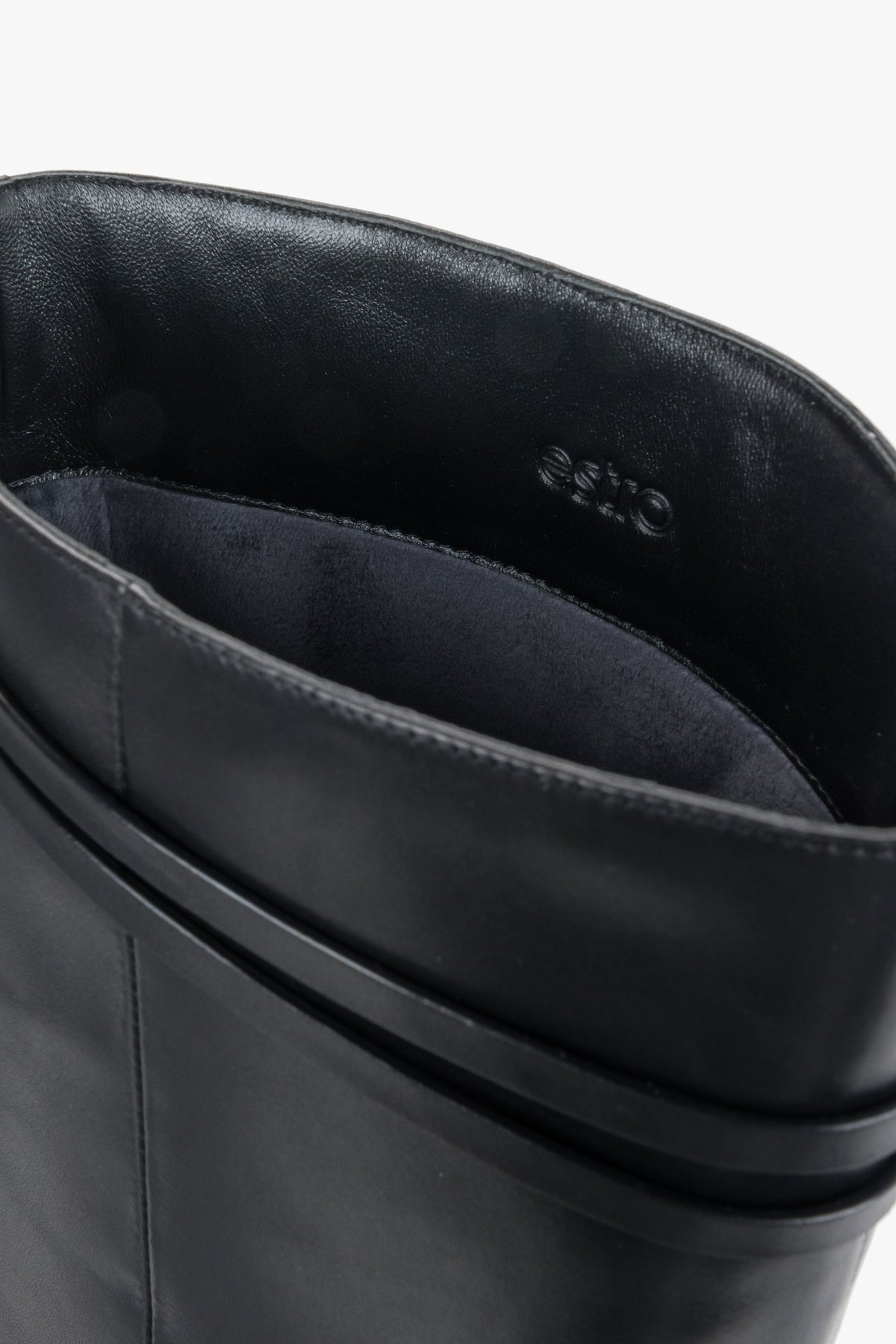 Women's black leather riding boots Estro - close-up view showing the genuine leather texture and hardware detailing.