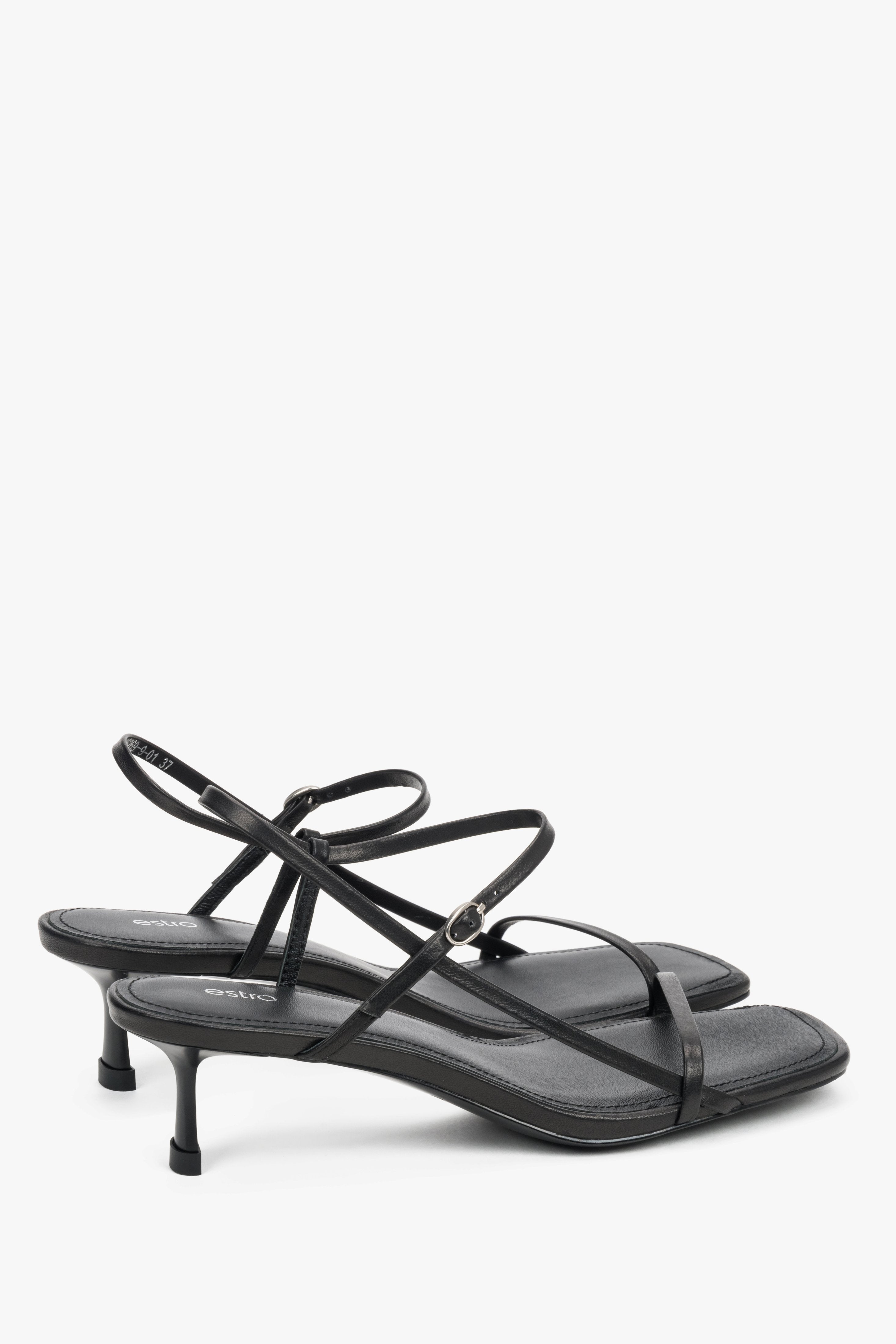 Women’s black leather low-heel sandals by Estro with thin straps.