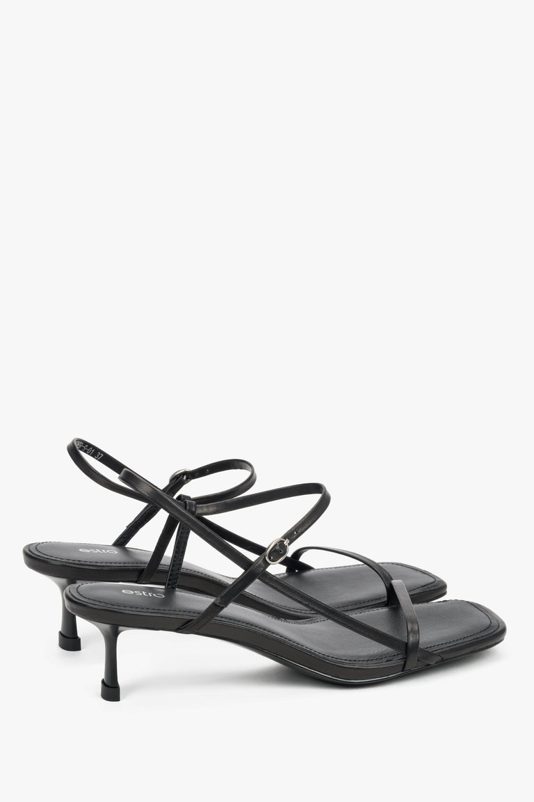 Women’s black leather low-heel sandals by Estro with thin straps.