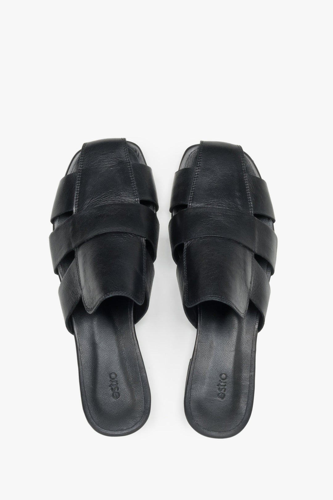 Backless pair of mules showcasing an interlaced front design, a fashionable square toe, and a smooth black insole featuring the brand logo.