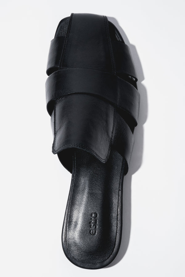 Backless pair of mules showcasing an interlaced front design, a fashionable square toe, and a smooth black insole featuring the brand logo.