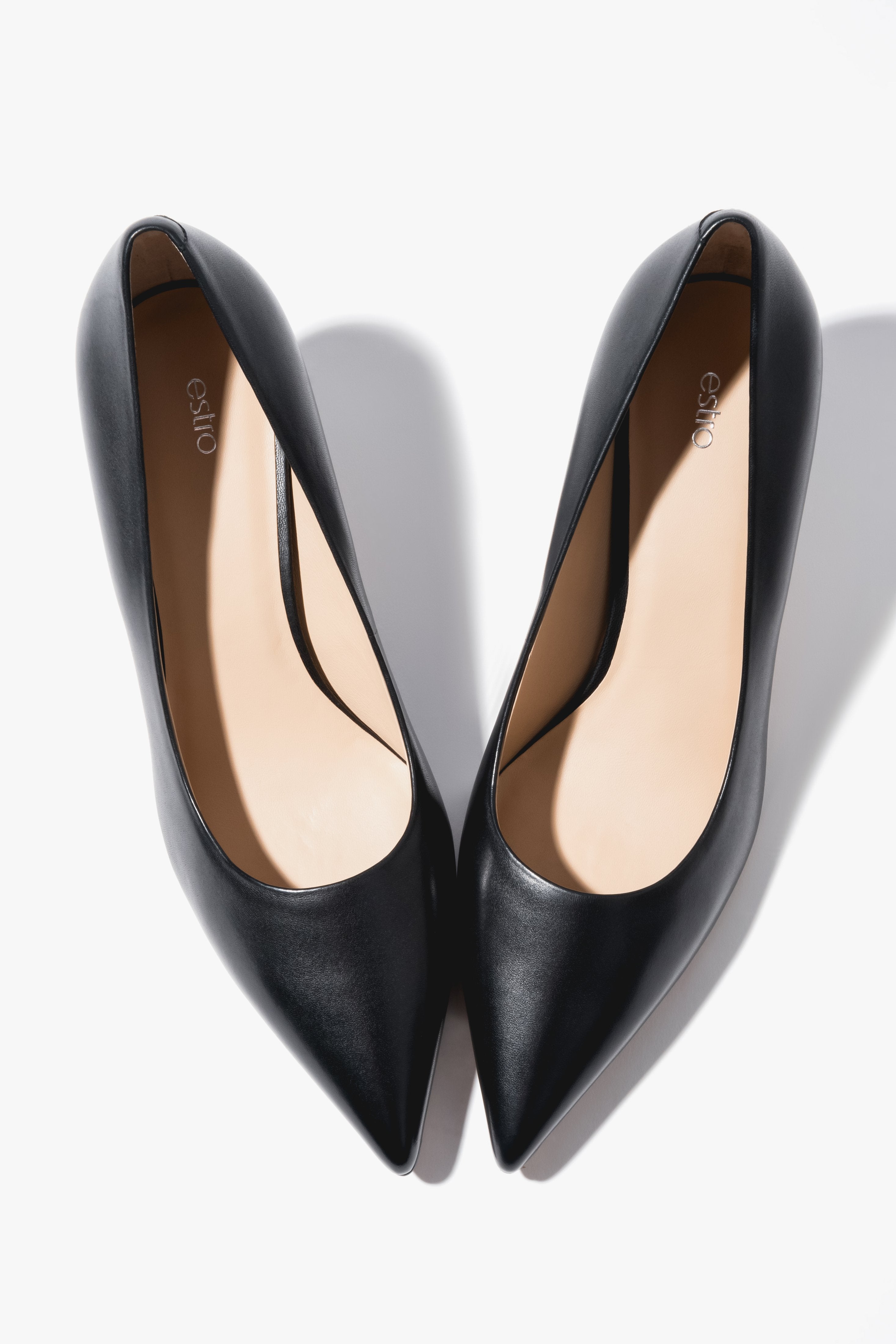 Close-up of the low heel on black leather shoes.