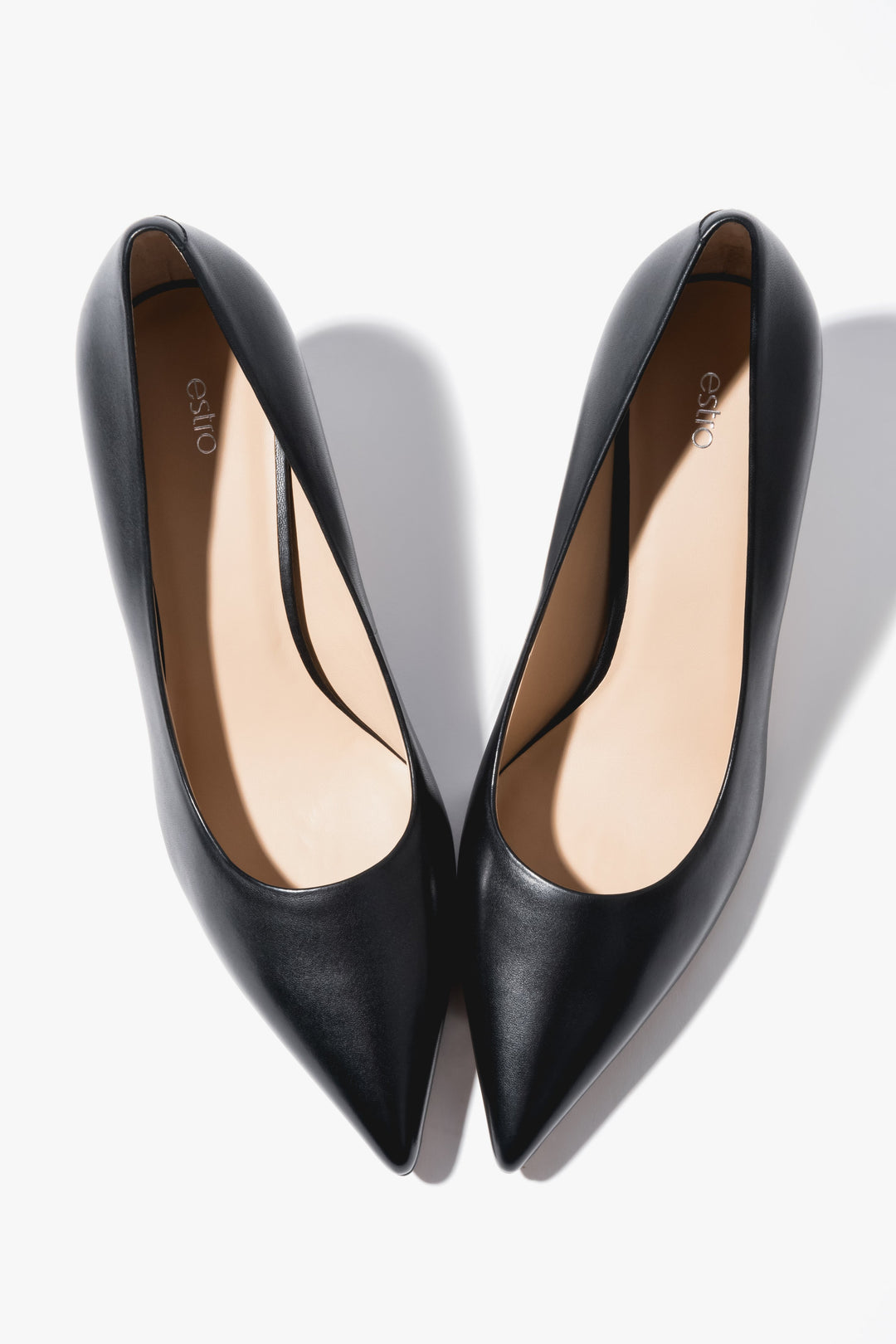 Close-up of the low heel on black leather shoes.