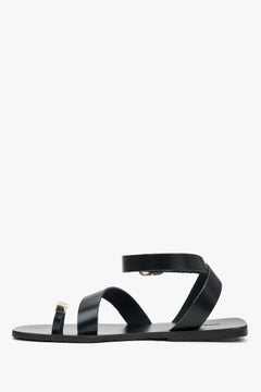 Women’s black leather sandals with a decorative toe ring by Estro – side view.