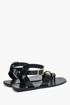 Women’s black sandals made of genuine leather with a decorative toe ring by Estro.