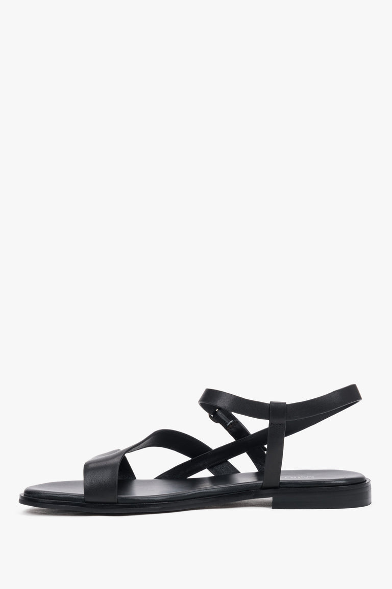Black women’s Estro leather sandals with crisscross straps and a flat sole.