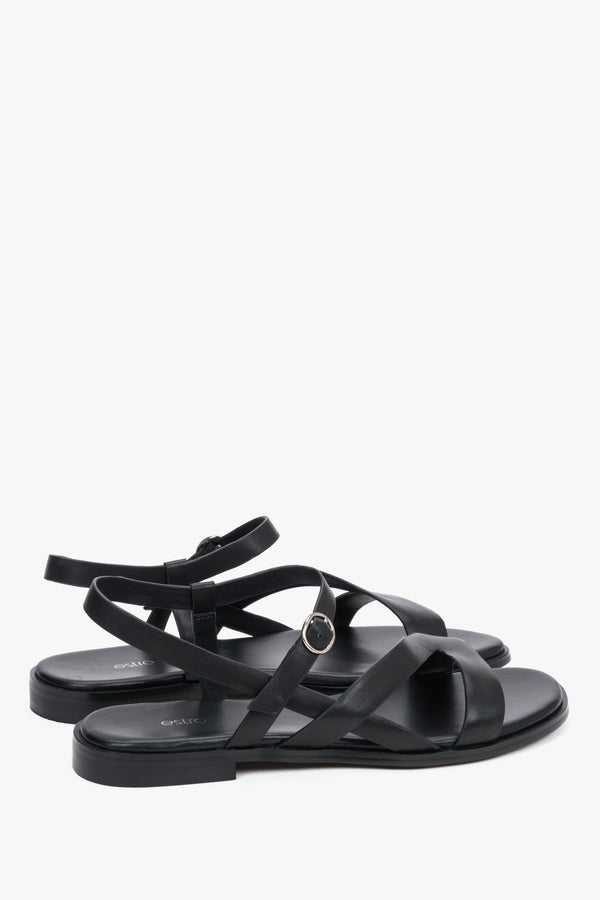 Black women’s Estro leather sandals on a flat sole with crisscross straps.