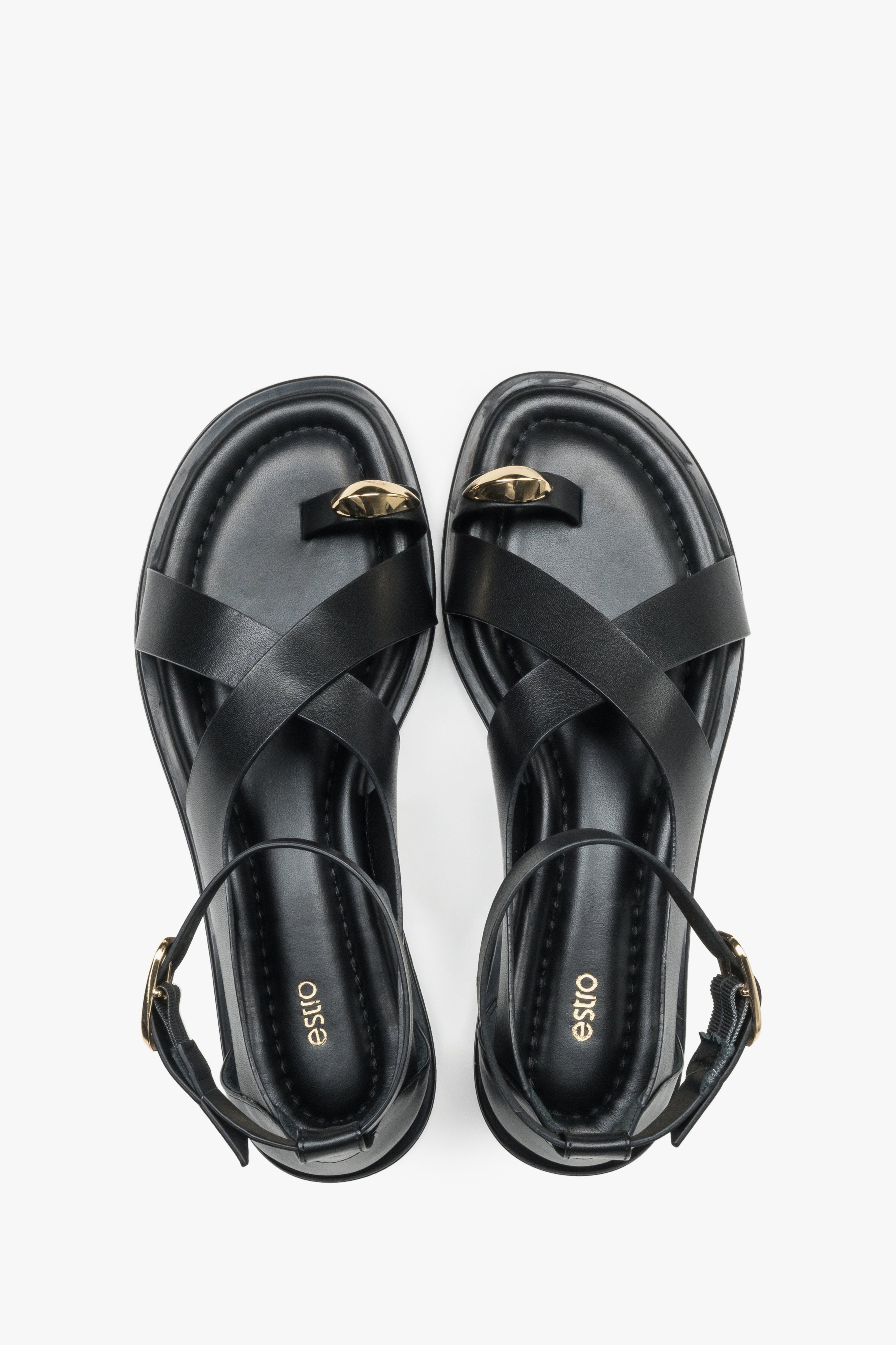 Top view of black leather Estro women’s sandals featuring a gold toe ring detail.