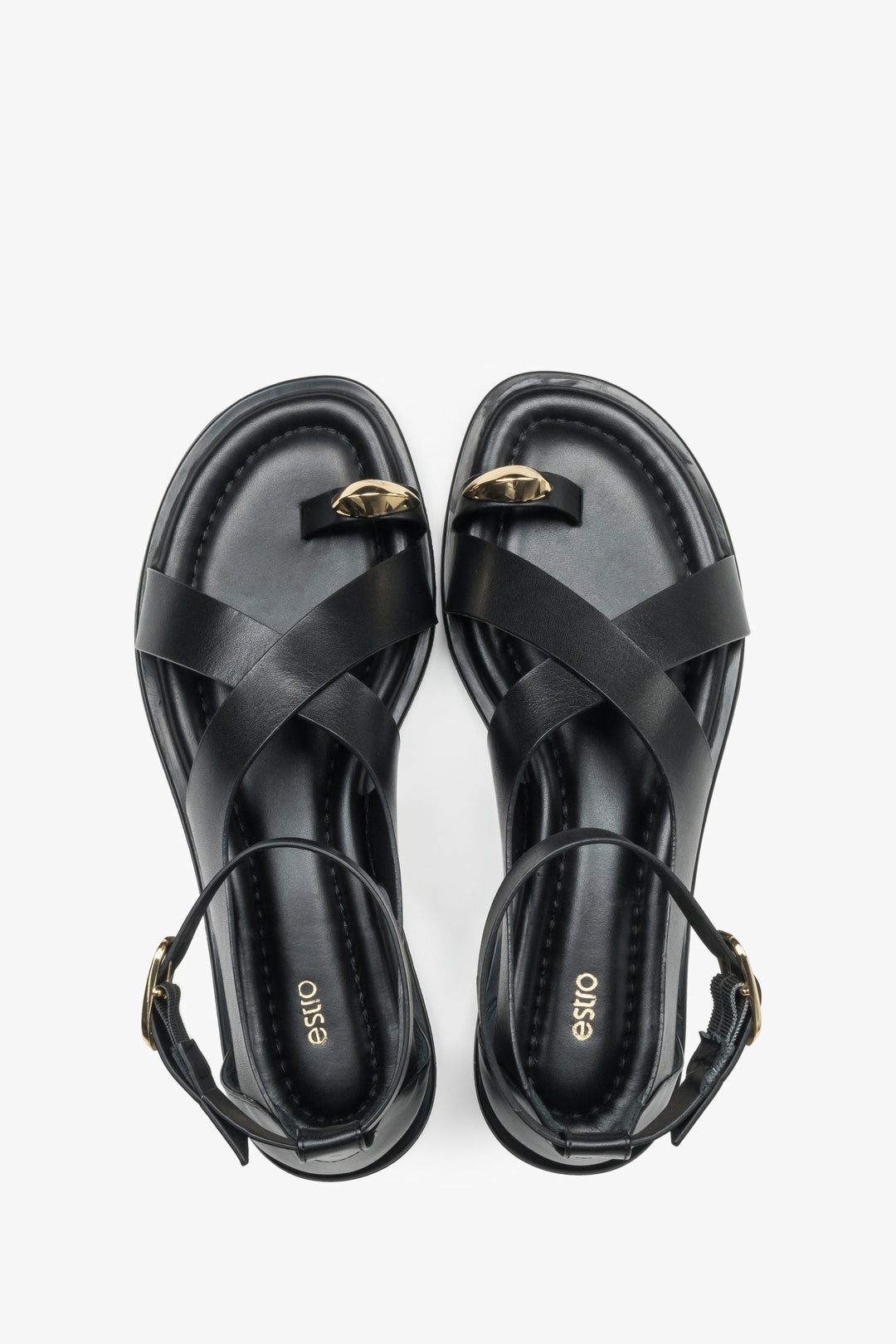 Top view of black leather Estro women’s sandals featuring a gold toe ring detail.