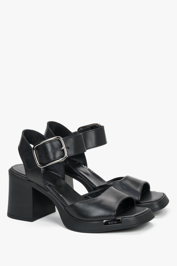 Black leather women’s sandals on a stable block heel with thick straps.