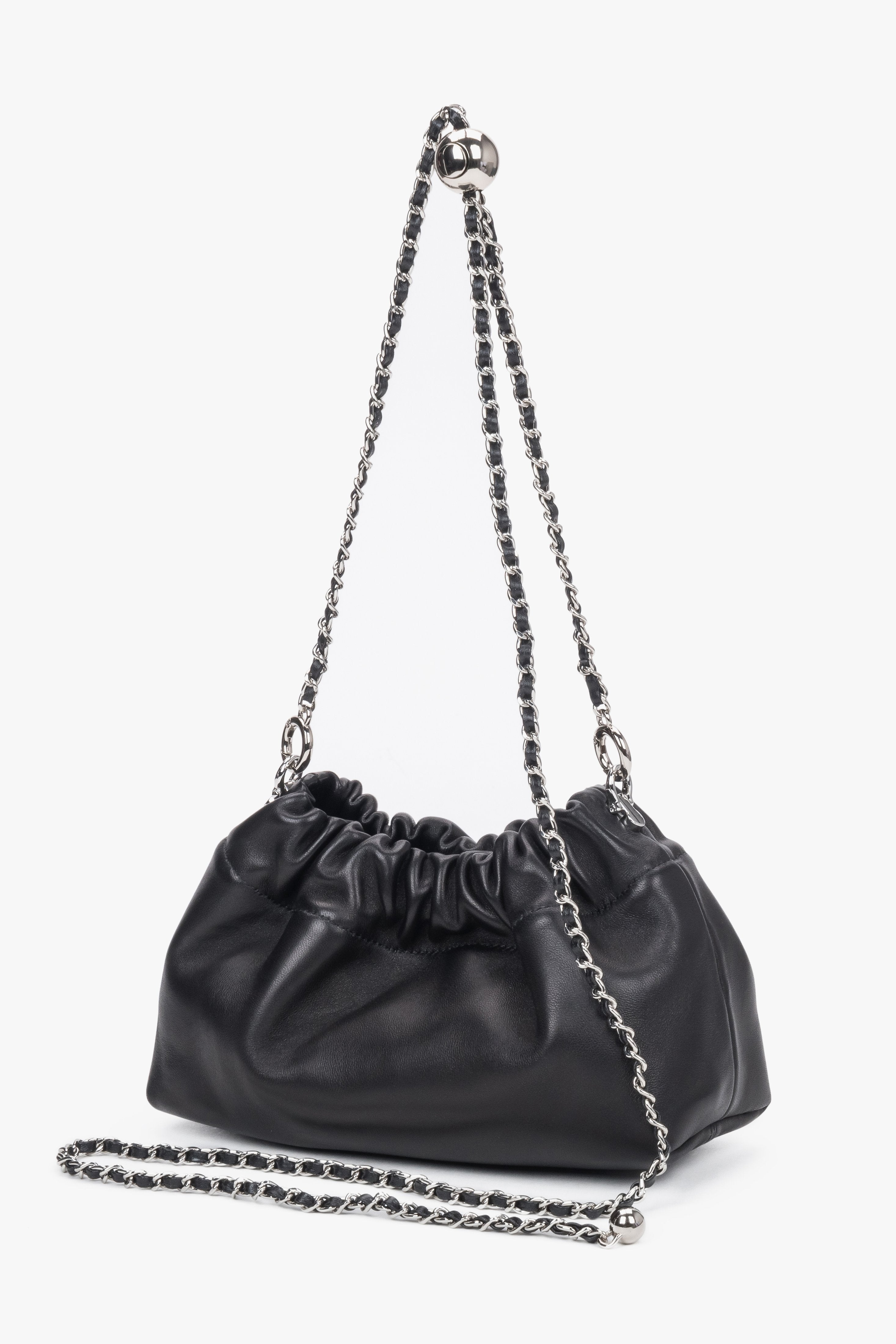 Front view of women's black leather shoulder bag with chain