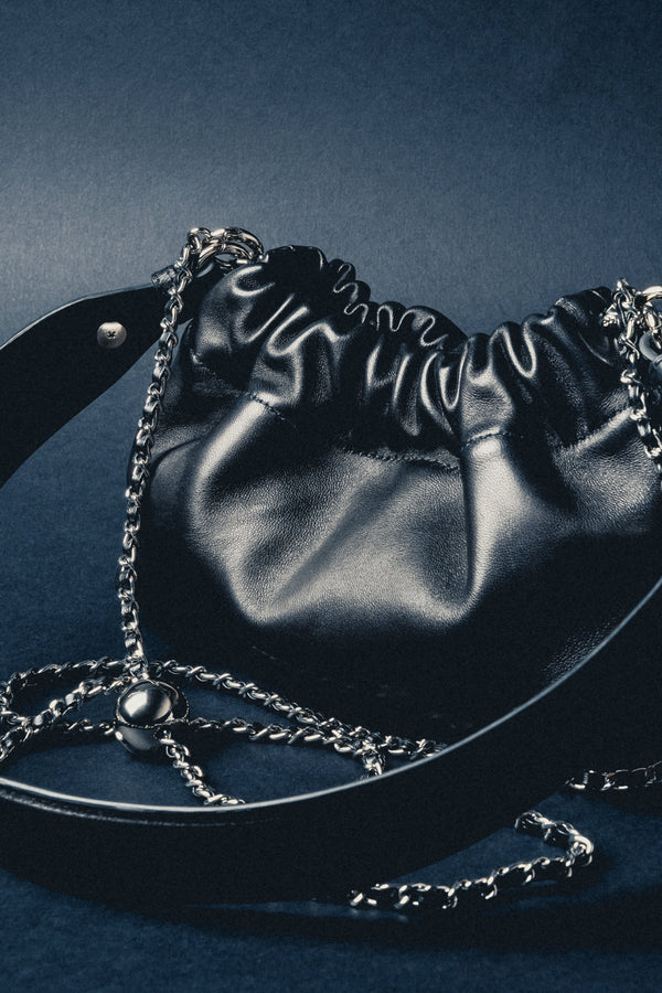 Detail view of women's black leather shoulder bag by Estro Selection