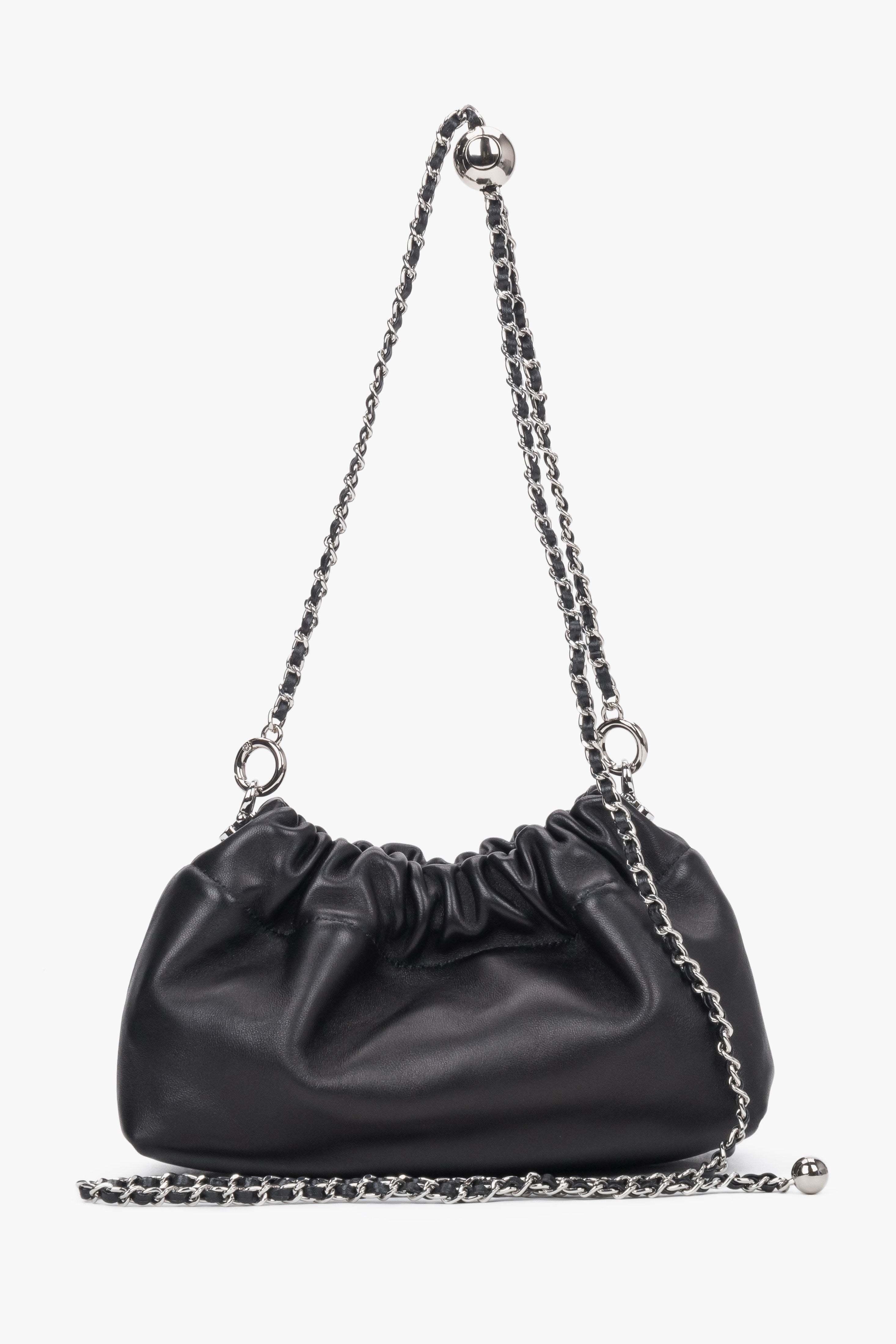 Side view of women's black leather shoulder bag with chain