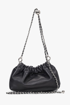 Side view of women's black leather shoulder bag with chain