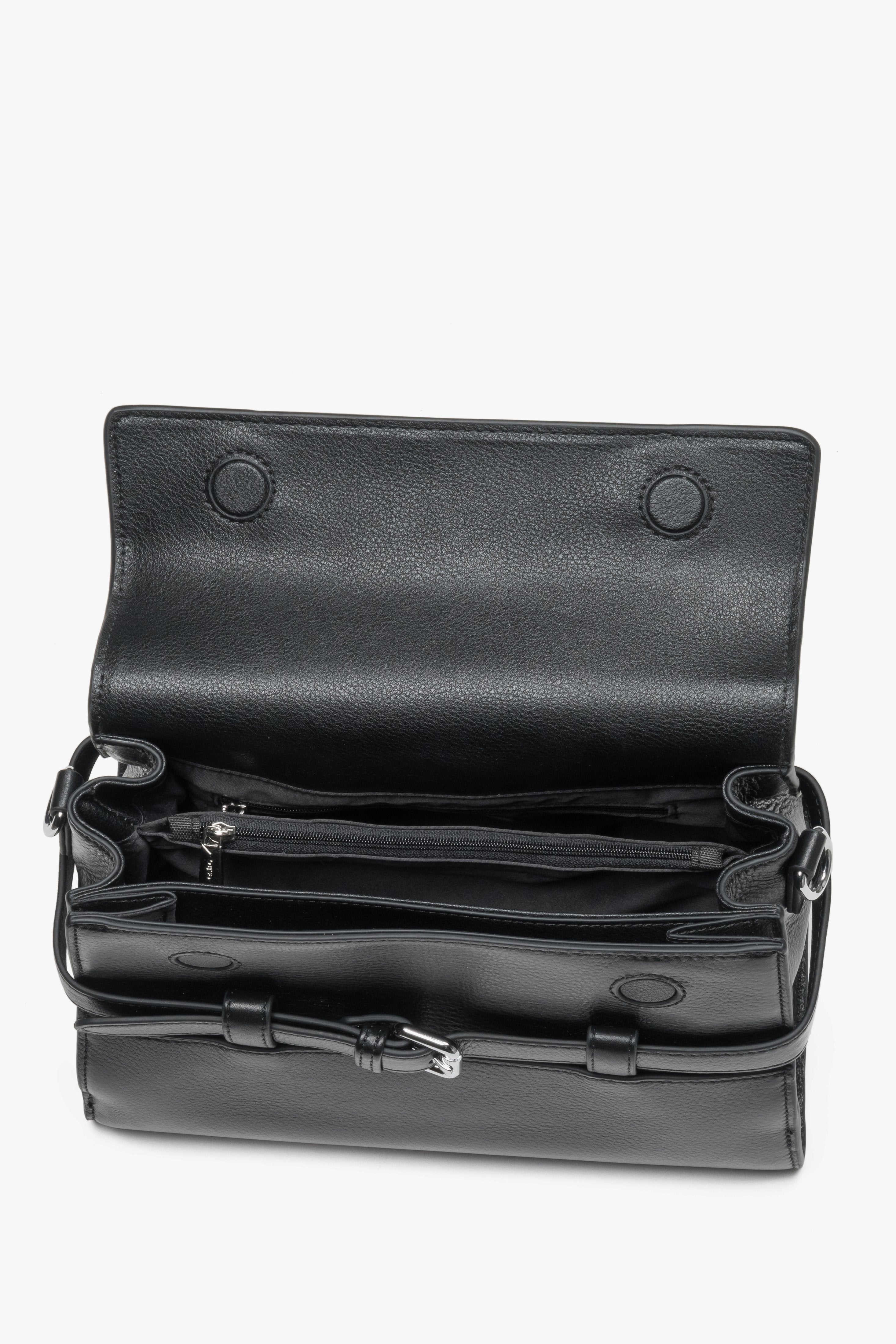 Interior view of women's black leather shoulder bag with compartments