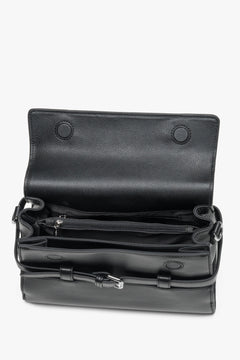 Interior view of women's black leather shoulder bag with compartments