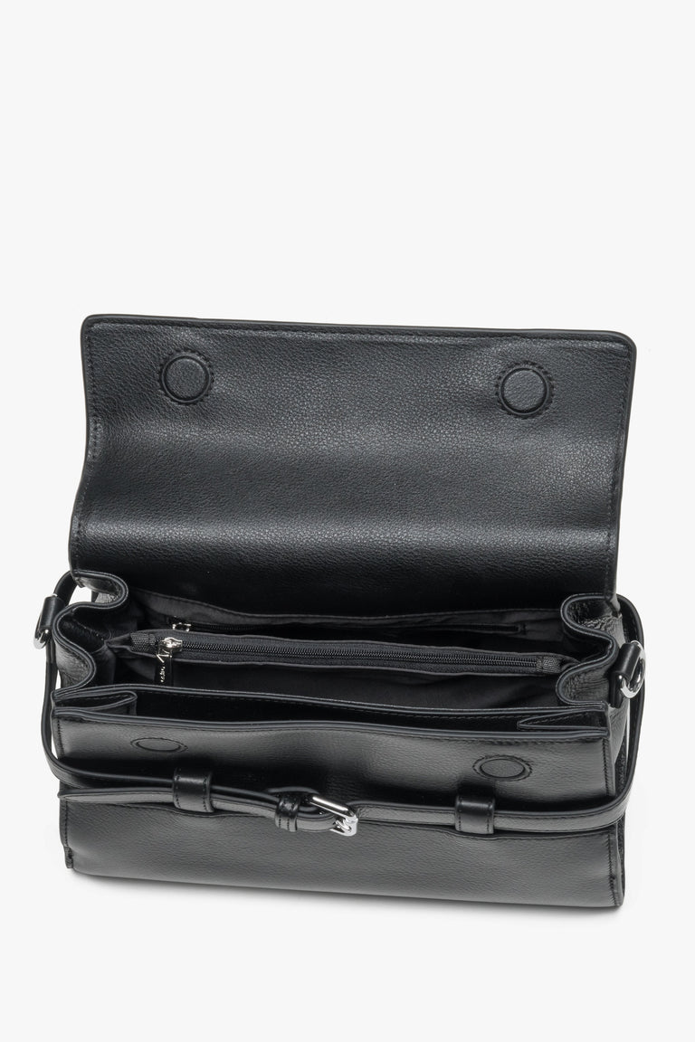 Interior view of women's black leather shoulder bag with compartments