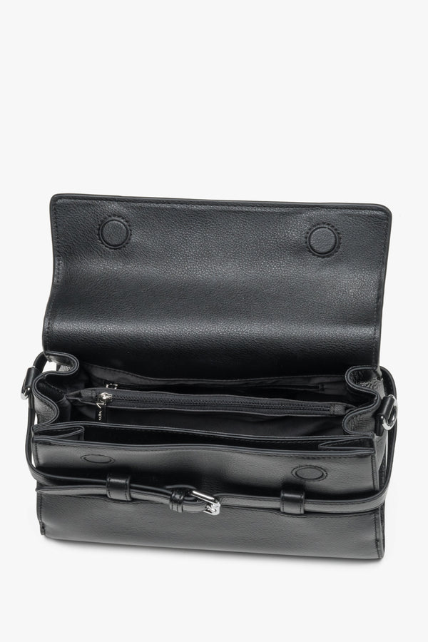Interior view of women's black leather shoulder bag with compartments