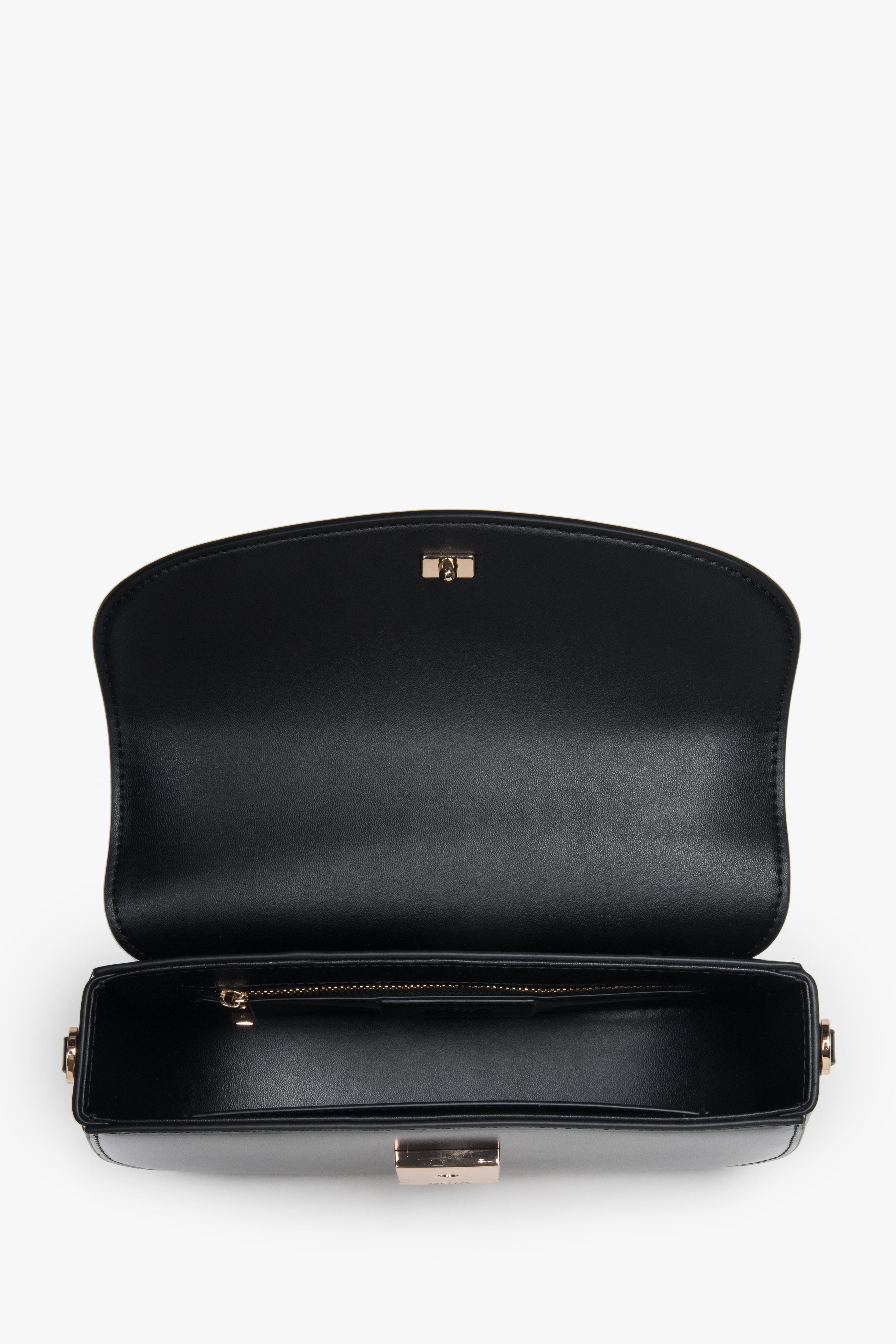 Versatile black shoulder bag with additional adjustable strap for crossbody wear.