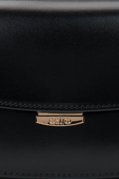 Timeless black leather bag with structured silhouette, perfect for everyday and evening looks.