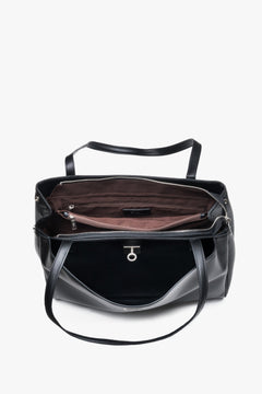 Interior view of women's black leather shoulder bag with compartments