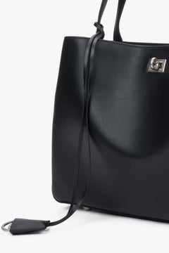 Detail view of women's black leather shoulder bag handle by Estro