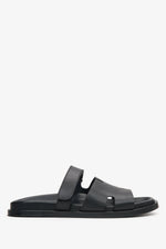 Elegant black leather slip-on sandals with flat sole and leather lining.