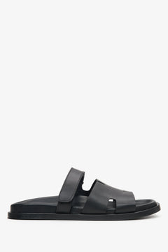 Elegant black leather slip-on sandals with flat sole and leather lining.