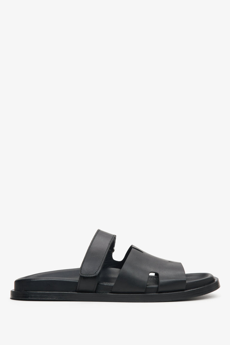 Elegant black leather slip-on sandals with flat sole and leather lining.