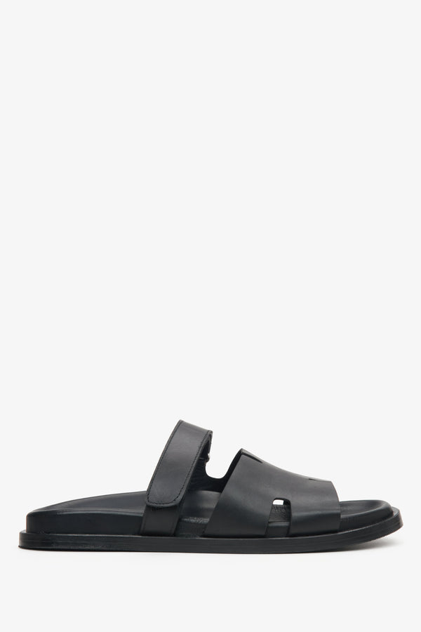 Elegant black leather slip-on sandals with flat sole and leather lining.