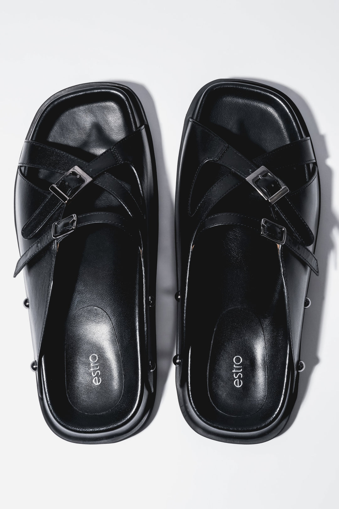 Women's black leather slide sandals with silver buckles by Estro