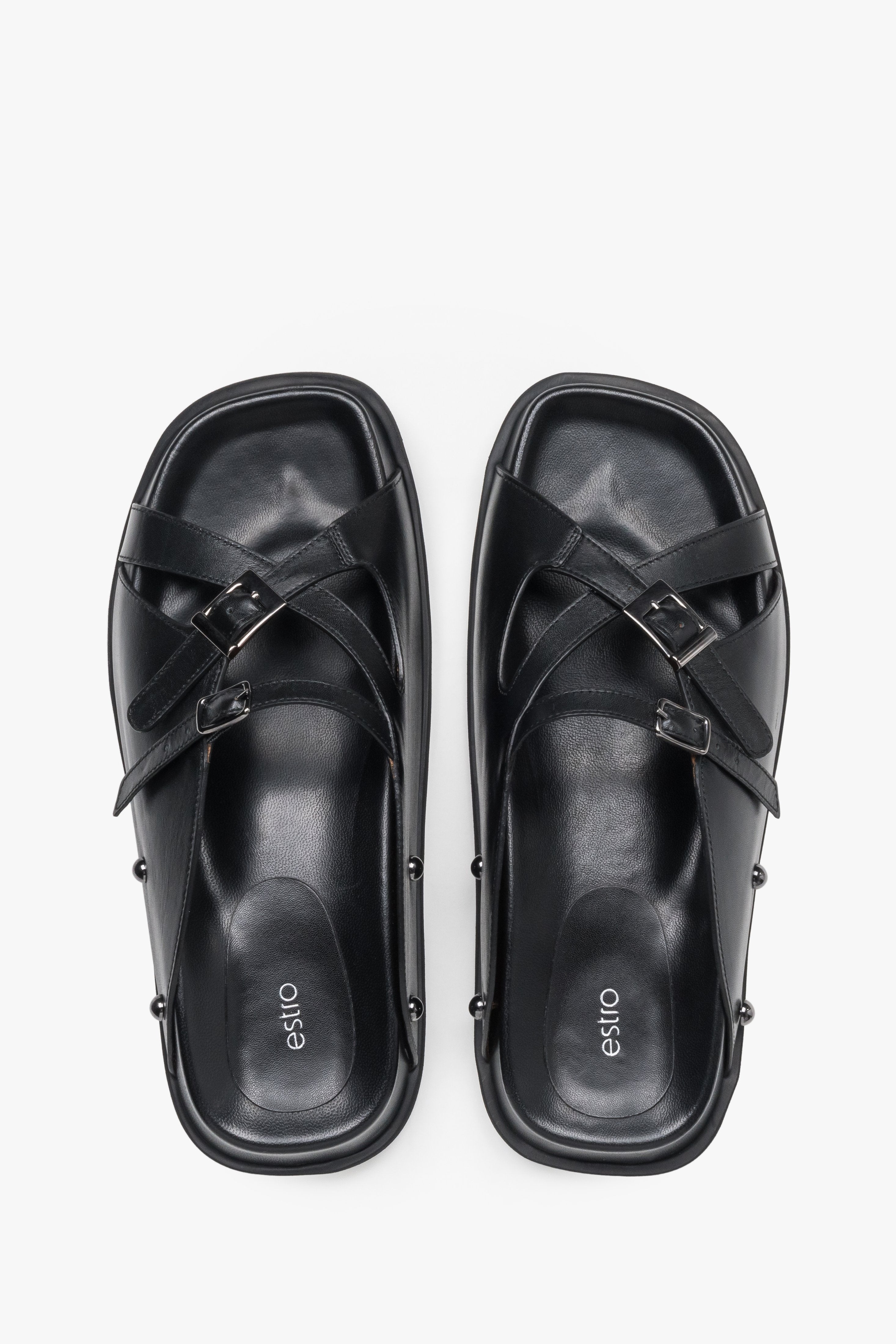 Top view of women's black leather slide sandals with silver buckles