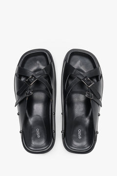 Top view of women's black leather slide sandals with silver buckles