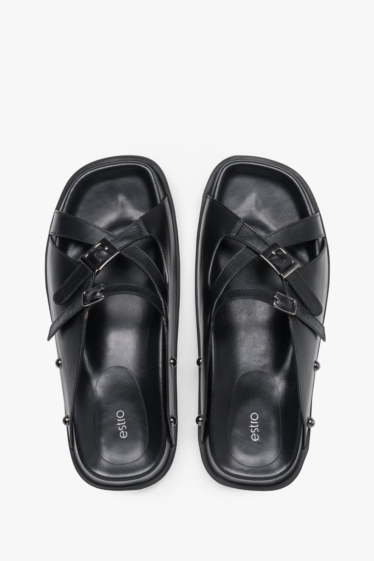 Top view of women's black leather slide sandals with silver buckles
