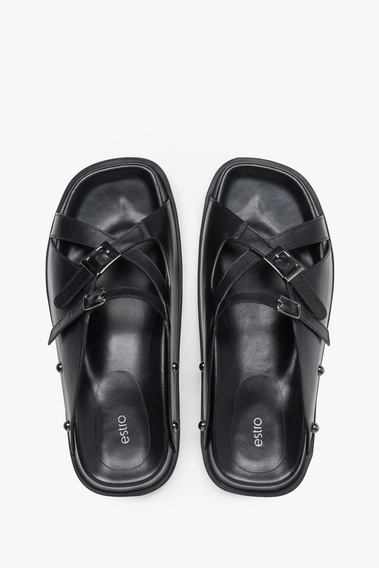 Top view of women's black leather slide sandals with silver buckles